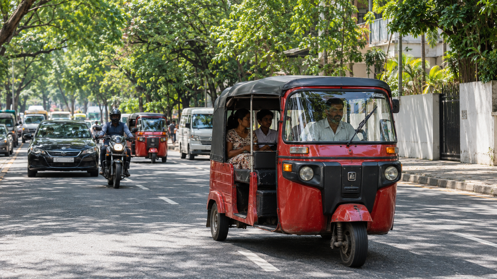 Tuk-tuk traveling along a leafy Colombo street